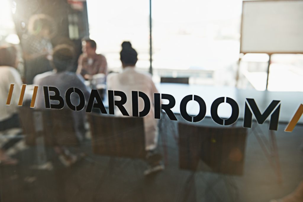 How you interact with your board.  Image of a group of young business colleagues in a boardroom meeting.